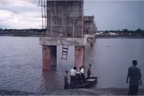 Scaffolding and formwork around a concrete bridge pier in water
